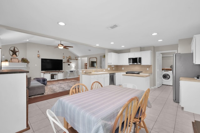 155 Fairwind Trail Dr, Conroe, TX 77385 - dining area with washer / clothes dryer, light tile patterned floors, a ceiling fan, lofted ceiling, and recessed lighting