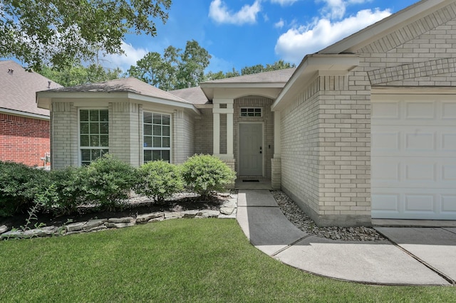 155 Fairwind Trail Dr, Conroe, TX 77385 - doorway to property featuring brick siding, a lawn, and an attached garage