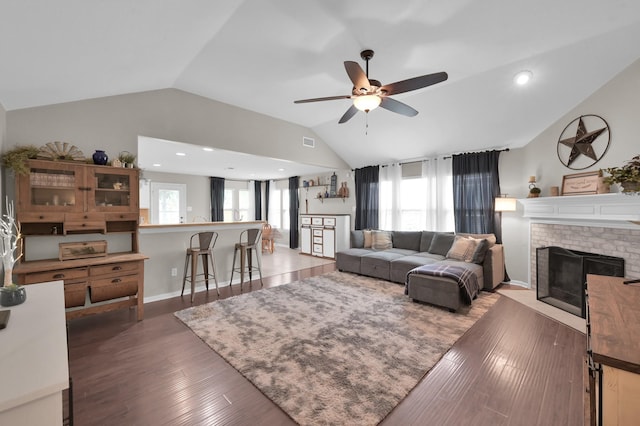 155 Fairwind Trail Dr, Conroe, TX 77385 - living room with lofted ceiling, a ceiling fan, wood finished floors, and a fireplace