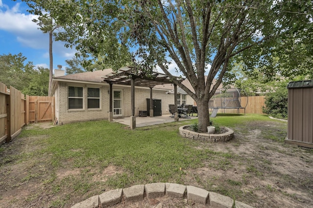 155 Fairwind Trail Dr, Conroe, TX 77385 - rear view of house with a trampoline, brick siding, a patio, a pergola, and a fenced backyard