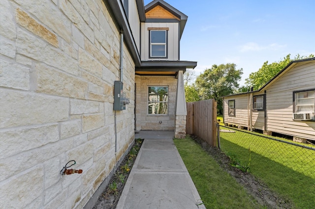 7407 Cora St, Houston, TX 77088 - view of exterior entry with stone siding and cooling unit