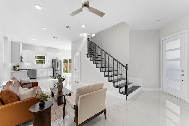 7407 Cora St, Houston, TX 77088 - living area featuring stairway, a ceiling fan, recessed lighting, and light marble finish flooring