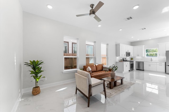 7407 Cora St, Houston, TX 77088 - living room with recessed lighting, light marble finish floors, and ceiling fan