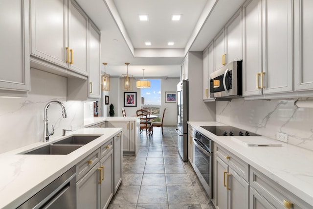 5100 San Felipe St Unit 353, Houston, TX 77056 - kitchen featuring appliances with stainless steel finishes, decorative backsplash, hanging light fixtures, gray cabinetry, and light stone countertops