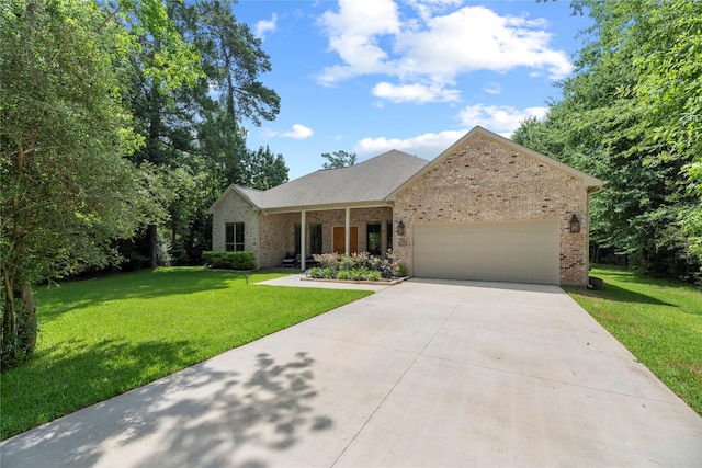 25010 Butler Hill Ct, Tomball, TX 77375 - view of front of home featuring driveway, brick siding, a garage, and a front yard