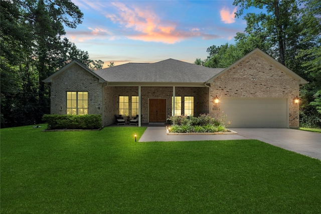 25010 Butler Hill Ct, Tomball, TX 77375 - ranch-style home with concrete driveway, an attached garage, brick siding, and a front yard