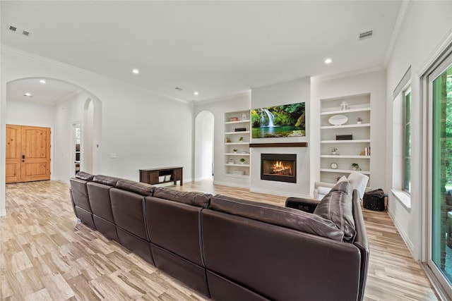 25010 Butler Hill Ct, Tomball, TX 77375 - living area featuring arched walkways, recessed lighting, light wood-style floors, built in features, and ornamental molding
