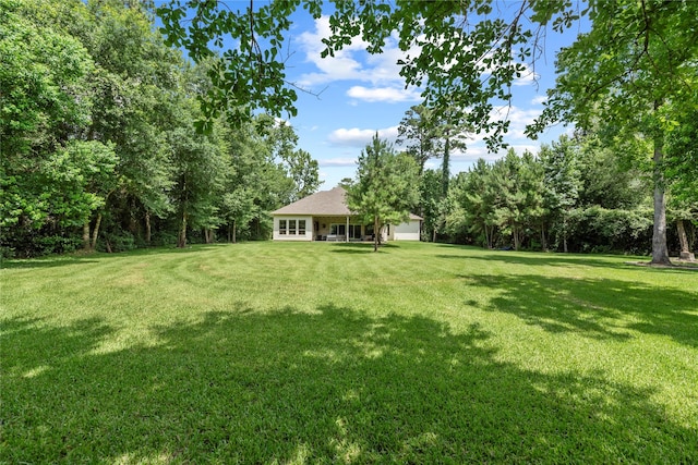 25010 Butler Hill Ct, Tomball, TX 77375 - view of grassy yard featuring a garage