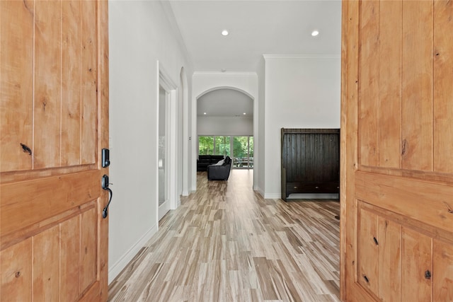 25010 Butler Hill Ct, Tomball, TX 77375 - entrance foyer featuring light wood-style flooring, ornamental molding, arched walkways, and recessed lighting