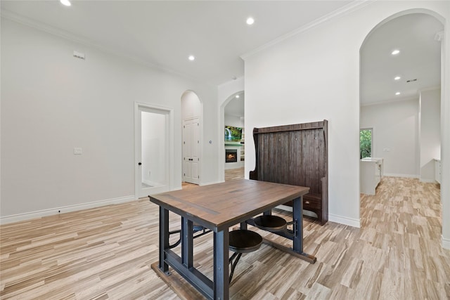 25010 Butler Hill Ct, Tomball, TX 77375 - dining space with arched walkways, light wood-style floors, recessed lighting, and crown molding