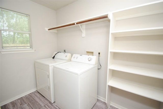 16827 Watering Oaks Ln, Houston, TX 77083 - laundry area with washer and dryer and light wood finished floors