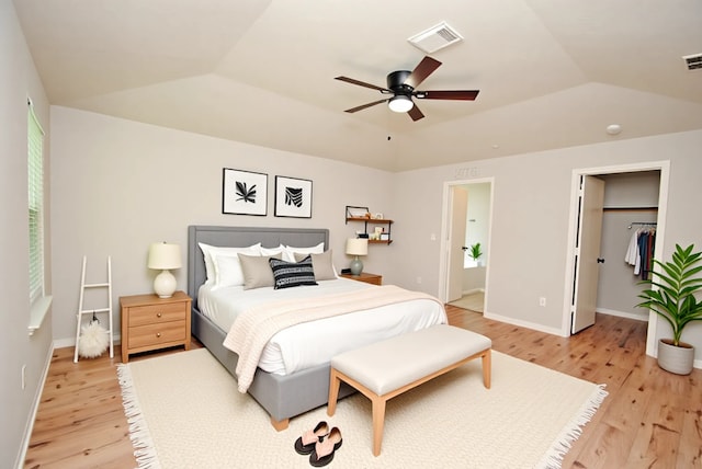 16827 Watering Oaks Ln, Houston, TX 77083 - bedroom with light wood finished floors, vaulted ceiling, ceiling fan, and a walk in closet