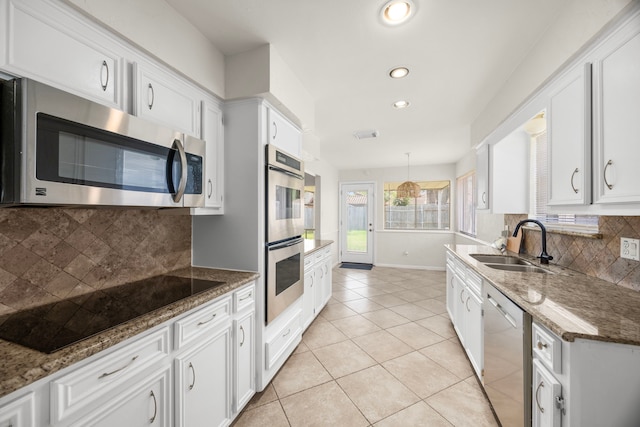 6114 Elkwood Forest Dr, Houston, TX 77088 - kitchen with stainless steel appliances, recessed lighting, white cabinetry, tasteful backsplash, and light tile patterned floors