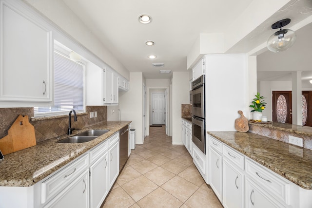 6114 Elkwood Forest Dr, Houston, TX 77088 - kitchen with tasteful backsplash, stainless steel appliances, white cabinets, light tile patterned flooring, and recessed lighting