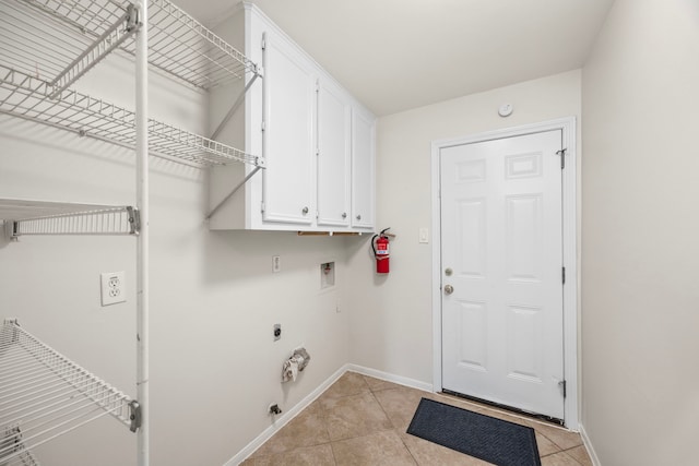 6114 Elkwood Forest Dr, Houston, TX 77088 - laundry area with hookup for a washing machine, cabinet space, light tile patterned floors, gas dryer hookup, and hookup for an electric dryer