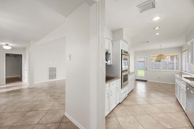 6114 Elkwood Forest Dr, Houston, TX 77088 - kitchen featuring appliances with stainless steel finishes, light tile patterned floors, white cabinets, recessed lighting, and decorative light fixtures