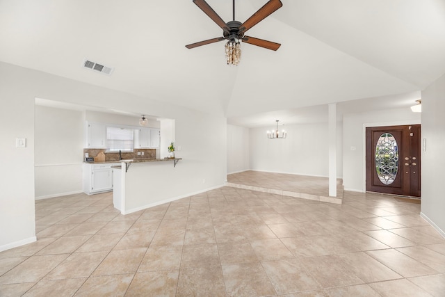6114 Elkwood Forest Dr, Houston, TX 77088 - unfurnished living room featuring high vaulted ceiling, a chandelier, light tile patterned flooring, ceiling fan, and healthy amount of natural light