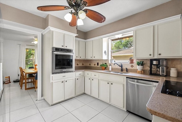 431 Shadow Creek Dr, El Lago, TX 77586 - kitchen featuring appliances with stainless steel finishes, ceiling fan, tasteful backsplash, and healthy amount of natural light