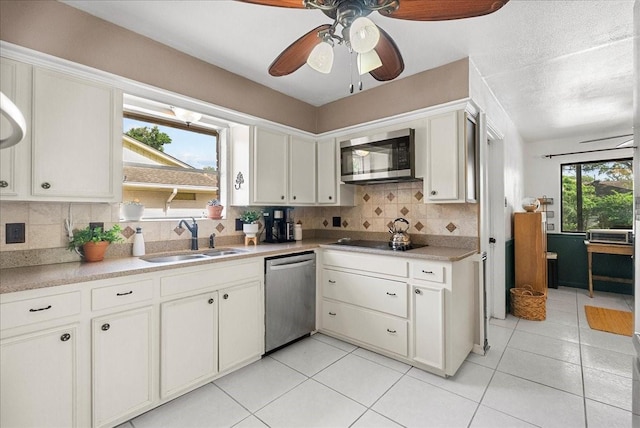 431 Shadow Creek Dr, El Lago, TX 77586 - kitchen featuring stainless steel appliances, backsplash, a ceiling fan, light tile patterned flooring, and light countertops