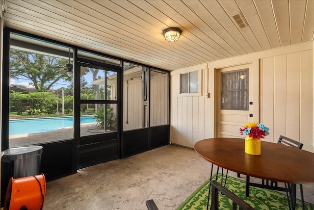 431 Shadow Creek Dr, El Lago, TX 77586 - doorway to outside featuring plenty of natural light, unfinished concrete floors, and wood ceiling