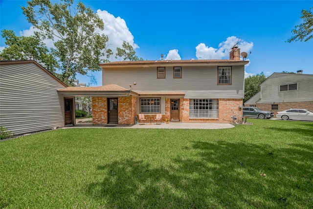 1015 Devonport Ln, Seabrook, TX 77586 - rear view of house with a chimney, a lawn, a patio, and brick siding