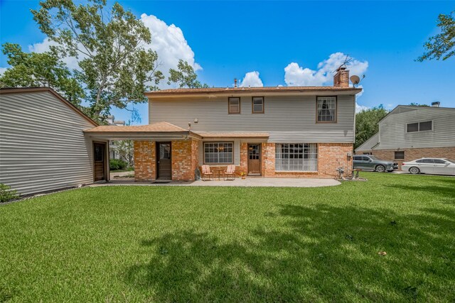 1015 Devonport Ln, Seabrook, TX 77586 - rear view of house with a chimney, a lawn, a patio, and brick siding