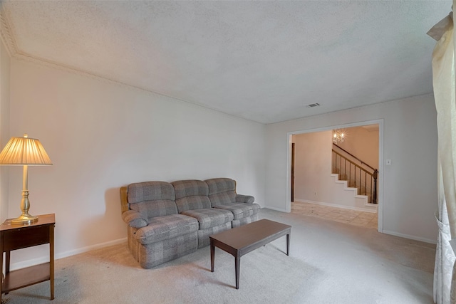 1015 Devonport Ln, Seabrook, TX 77586 - living room with stairs, carpet flooring, a textured ceiling, and a chandelier