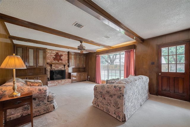 1015 Devonport Ln, Seabrook, TX 77586 - living area with a textured ceiling, light carpet, wood walls, plenty of natural light, and a fireplace