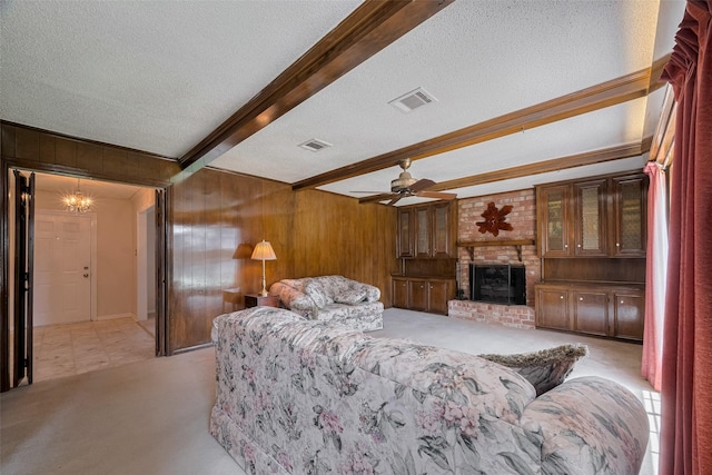 1015 Devonport Ln, Seabrook, TX 77586 - living room featuring wooden walls, beamed ceiling, light colored carpet, a textured ceiling, and a fireplace