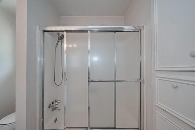 1015 Devonport Ln, Seabrook, TX 77586 - bathroom with toilet and bath / shower combo with glass door