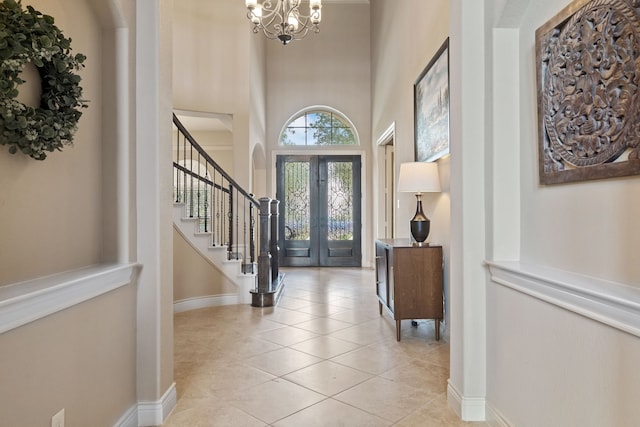 4314 Madera Creek Ln, Katy, TX 77494 - foyer entrance with a chandelier, stairs, light tile patterned flooring, a towering ceiling, and french doors