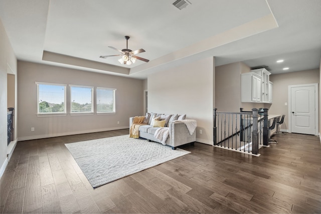 4314 Madera Creek Ln, Katy, TX 77494 - living area featuring a raised ceiling, dark wood-style flooring, an upstairs landing, a ceiling fan, and recessed lighting