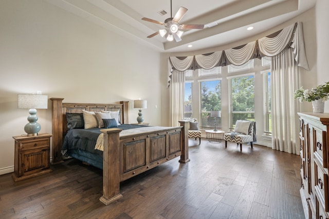 4314 Madera Creek Ln, Katy, TX 77494 - bedroom featuring dark wood-type flooring, a tray ceiling, a towering ceiling, and recessed lighting