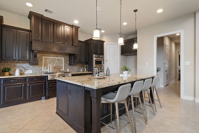 4314 Madera Creek Ln, Katy, TX 77494 - kitchen with stainless steel gas cooktop, tasteful backsplash, light tile patterned floors, and recessed lighting