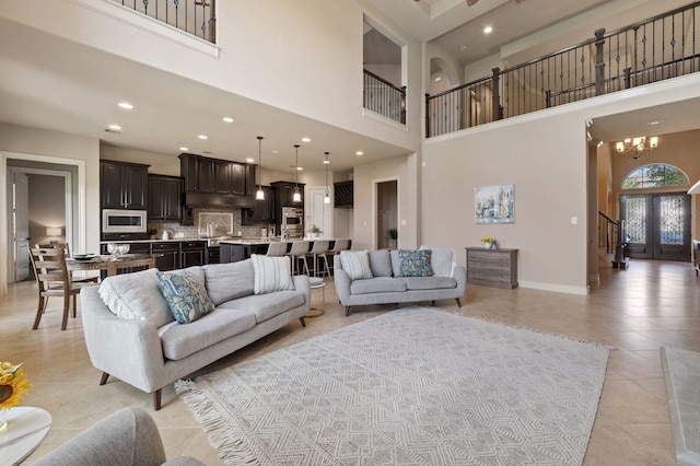 4314 Madera Creek Ln, Katy, TX 77494 - living room with a chandelier, a high ceiling, light tile patterned floors, stairway, and recessed lighting