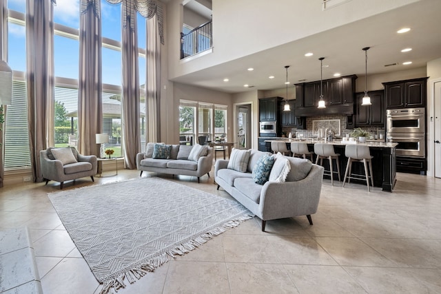 4314 Madera Creek Ln, Katy, TX 77494 - living room featuring a towering ceiling, light tile patterned flooring, and recessed lighting