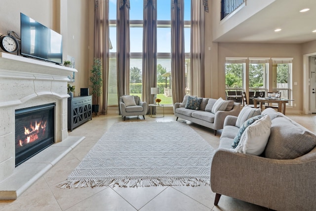 4314 Madera Creek Ln, Katy, TX 77494 - tiled living area featuring a towering ceiling, a water view, a glass covered fireplace, and recessed lighting