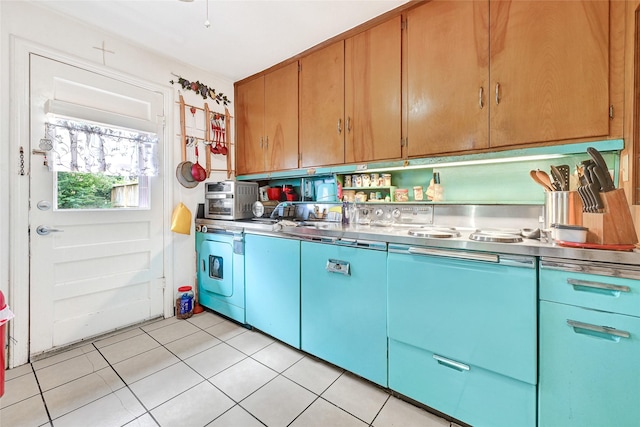 1012 Joyce St, Houston, TX 77009 - kitchen featuring stainless steel counters, light tile patterned floors, and washing machine and dryer