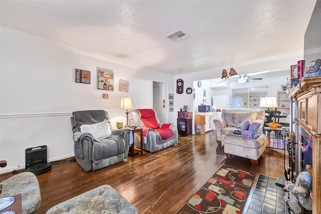 1012 Joyce St, Houston, TX 77009 - living area with hardwood / wood-style flooring, crown molding, ceiling fan, and a textured ceiling