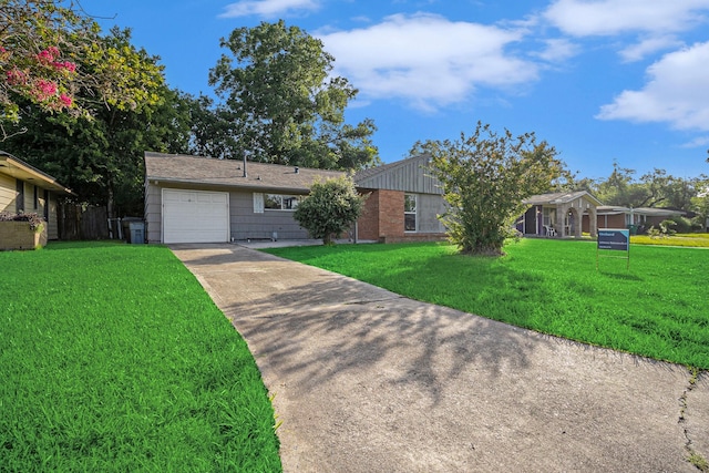 5715 Willow Glen Dr, Houston, TX 77033 - view of front facade with concrete driveway, a front yard, an attached garage, and brick siding