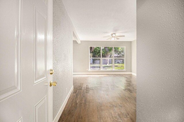 5715 Willow Glen Dr, Houston, TX 77033 - spare room with a textured wall, wood finished floors, and a ceiling fan