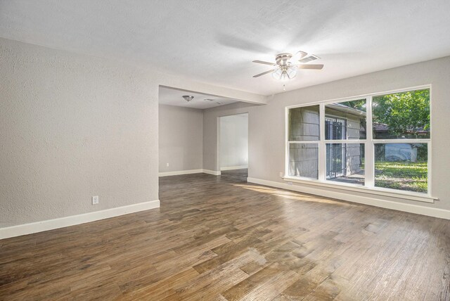 5715 Willow Glen Dr, Houston, TX 77033 - empty room featuring a textured wall, ceiling fan, and wood finished floors