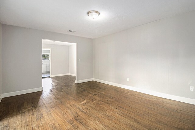 5715 Willow Glen Dr, Houston, TX 77033 - unfurnished room with dark wood-type flooring and baseboards
