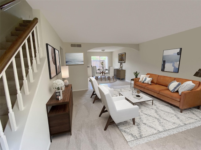3100 Jeanetta St Unit 304, Houston, TX 77063 - living room featuring arched walkways, stairway, and light colored carpet