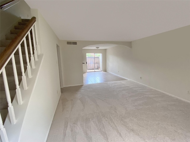3100 Jeanetta St Unit 304, Houston, TX 77063 - unfurnished living room with arched walkways, carpet, and stairway