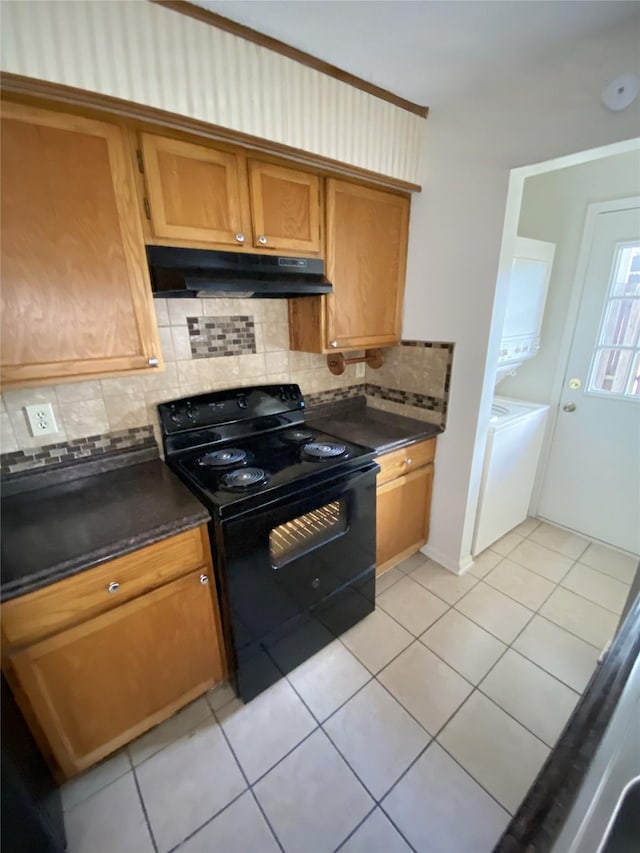 3100 Jeanetta St Unit 304, Houston, TX 77063 - kitchen featuring black range with electric stovetop, under cabinet range hood, light tile patterned flooring, and dark countertops