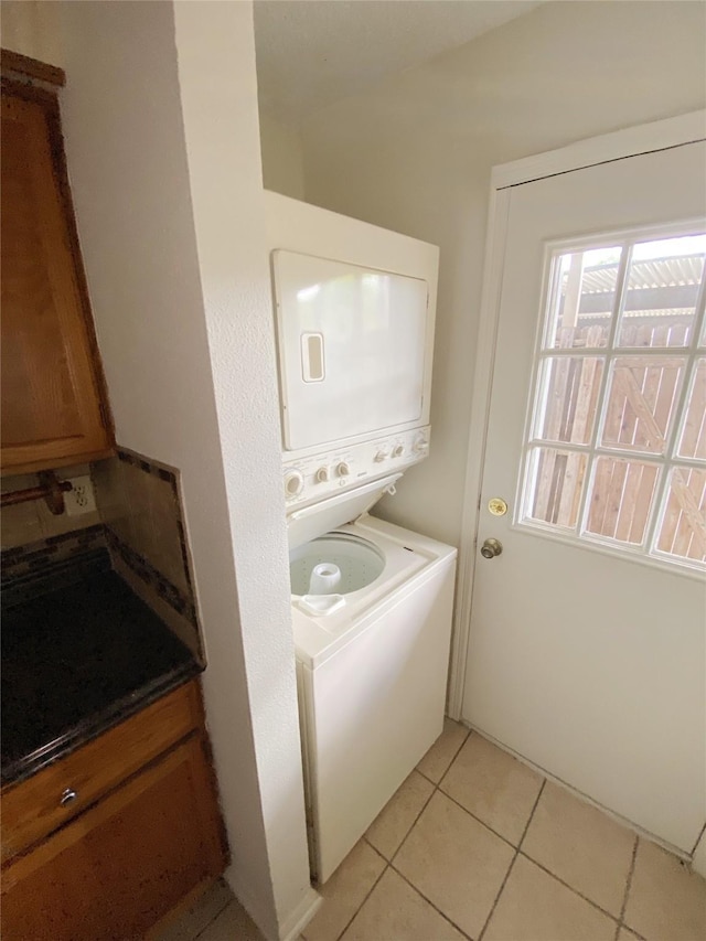 3100 Jeanetta St Unit 304, Houston, TX 77063 - laundry room with estacked washer and dryer and light tile patterned floors