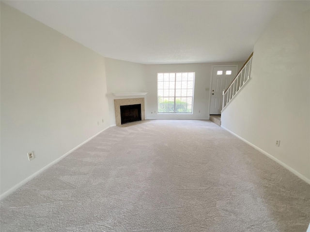 3100 Jeanetta St Unit 304, Houston, TX 77063 - unfurnished living room featuring carpet, a fireplace, and stairway