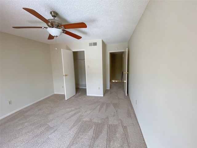 3100 Jeanetta St Unit 304, Houston, TX 77063 - unfurnished bedroom with light colored carpet, a textured ceiling, and a ceiling fan