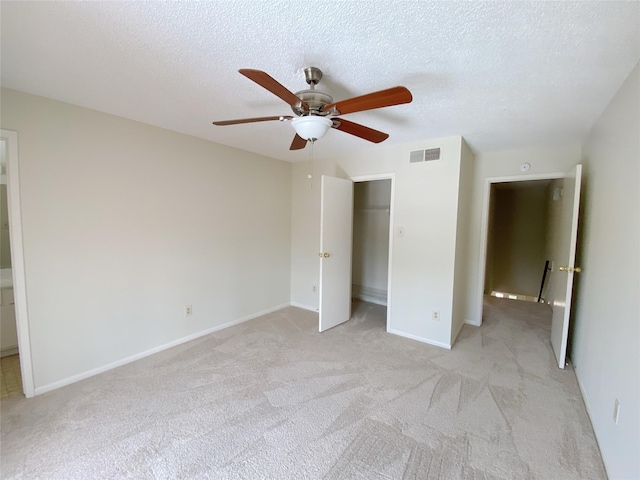 3100 Jeanetta St Unit 304, Houston, TX 77063 - unfurnished bedroom featuring light colored carpet, a textured ceiling, a ceiling fan, and a closet